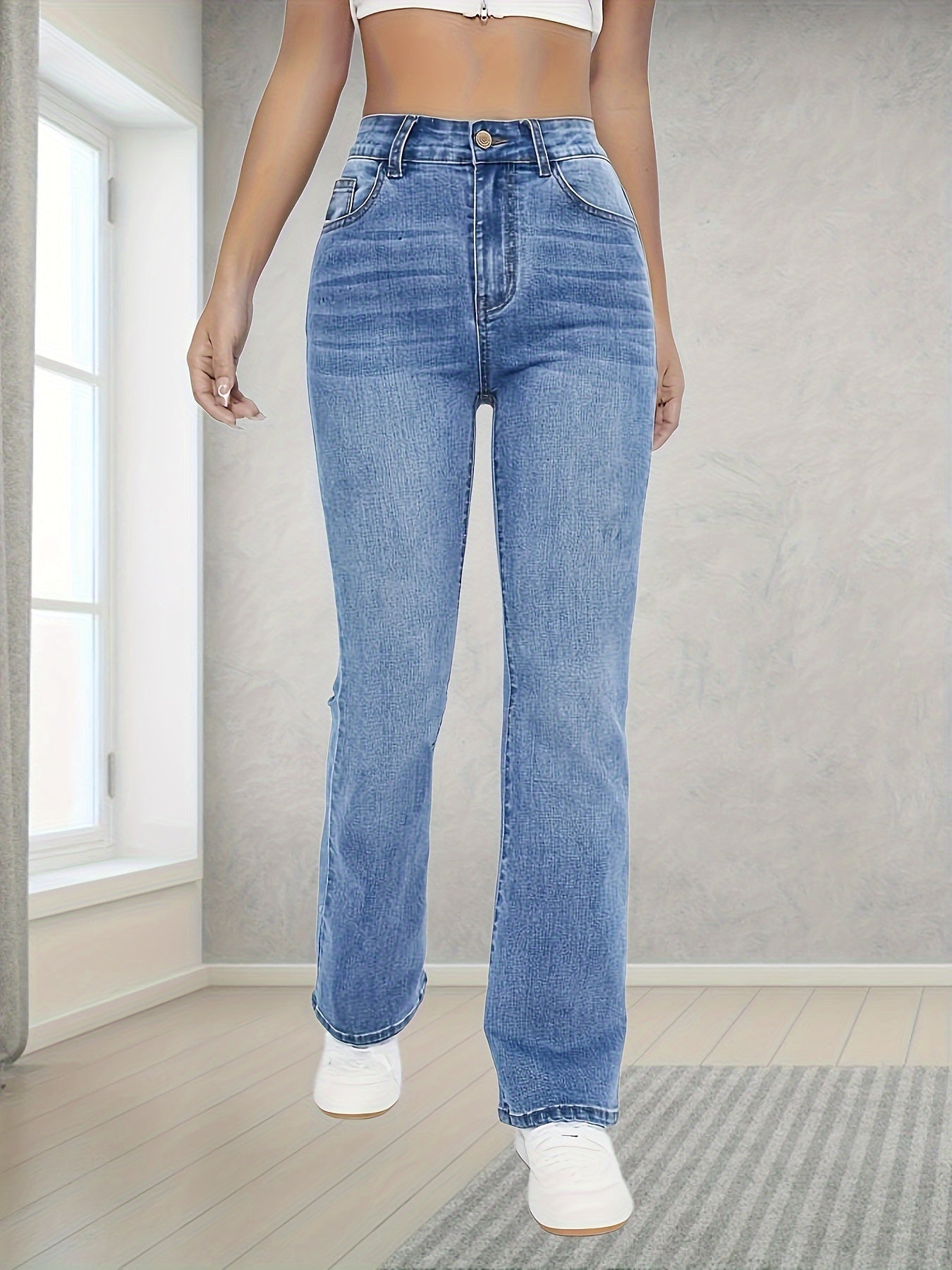 Washed blue flare leg jeans with stretch, slant pockets, and bell bottom design for women.