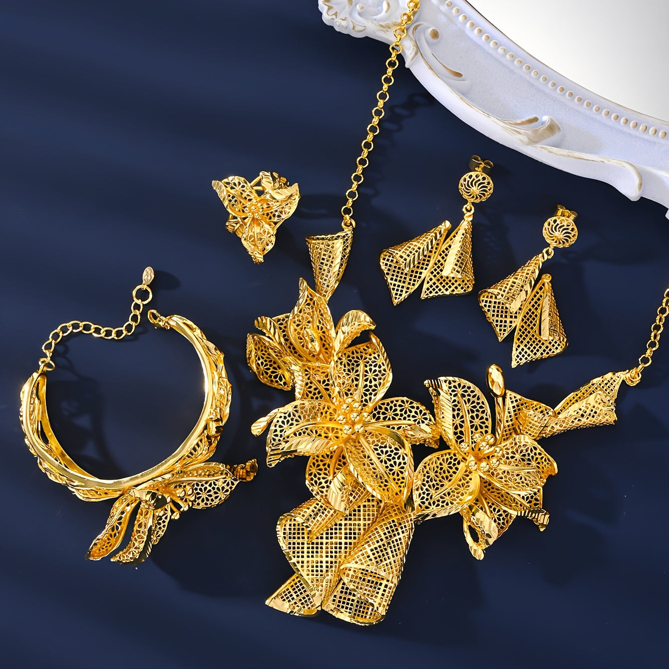 A luxurious jewelry set plated with 18K gold, showcasing a stunning floral necklace, a versatile adjustable ring, and charming pendant earrings - ideal for both everyday wear and special occasions.