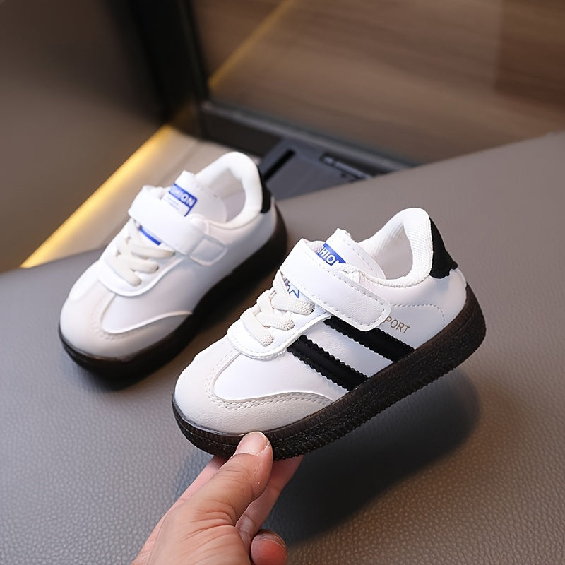 Minimalist unisex toddler sneakers with solid color, adjustable strap closure, slip-resistant sole, and breathable fabric.