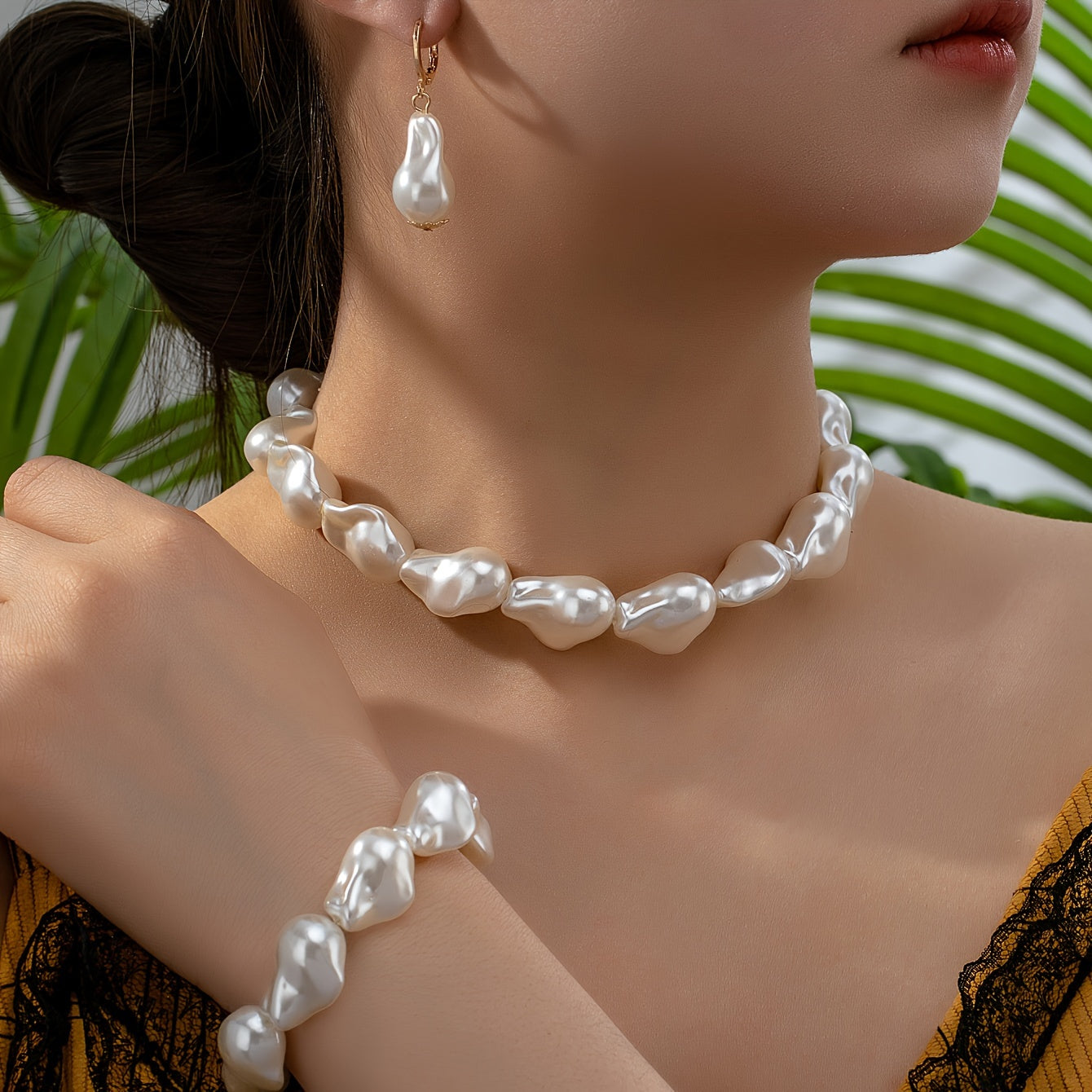 This women's jewelry set features elegant imitation pearls with a simple, un-plated design. The set includes a baroque pearl necklace, bracelet, and earrings, making it versatile for everyday wear. The unique geometric shape design adds a touch of