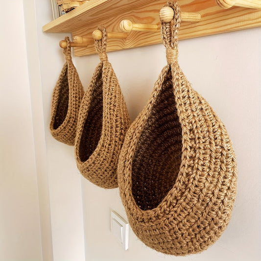 Set of 3 hanging baskets made of cotton rope and sisal crochet, featuring water drops design. This versatile storage solution can be used as a fruit, vegetable, or plant holder, or as a kitchen organizer. Hang them on the wall to save space and add a