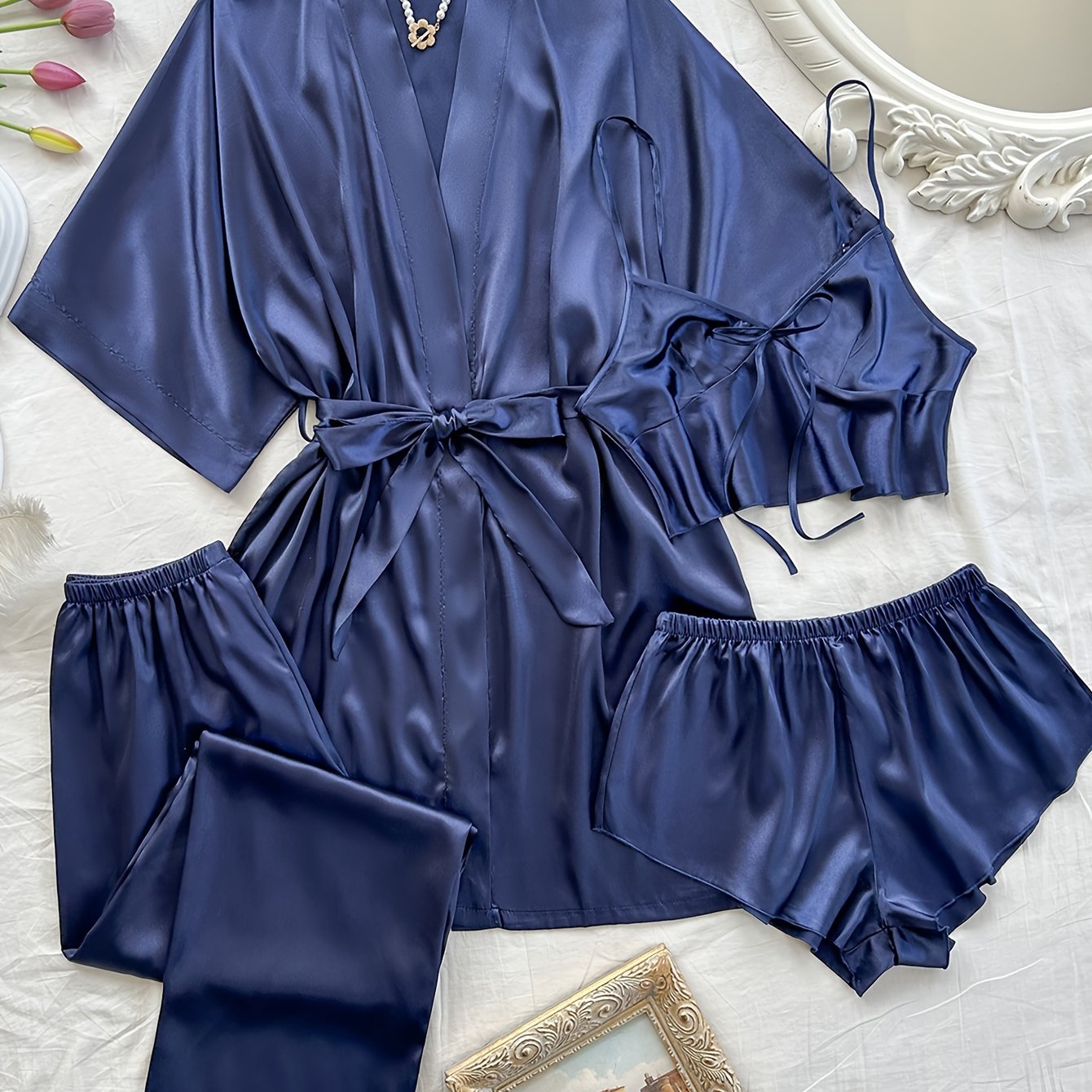 Women's 4-piece satin pajama set includes V-neck robe, lingerie top, shorts, and long pants in solid color. Made of comfortable woven polyester for all-season sleepwear.