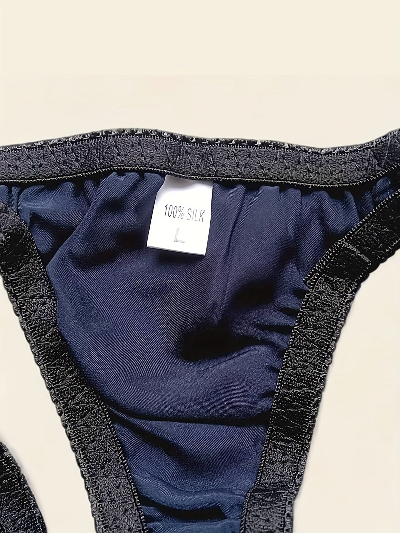 Men's Mulberry Silky Briefs are soft, breathable, non-see-through red underwear with an elastic waistband and ruffled edges. Hand wash only.