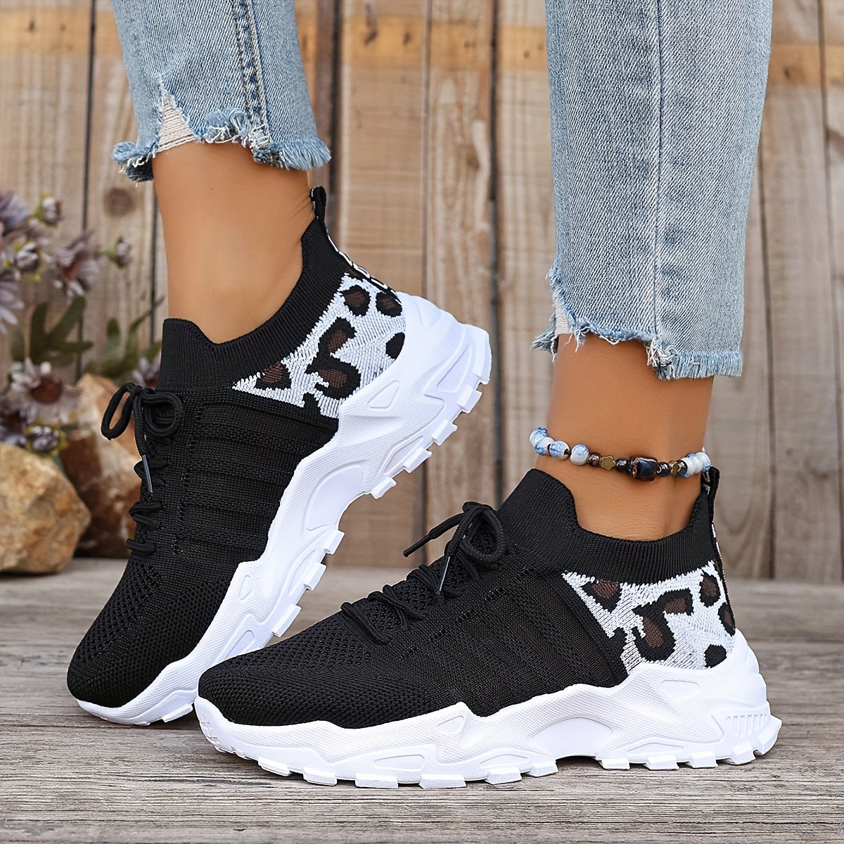 Breathable mesh leopard print sneakers with comfortable platform sole and stylish low-top design.