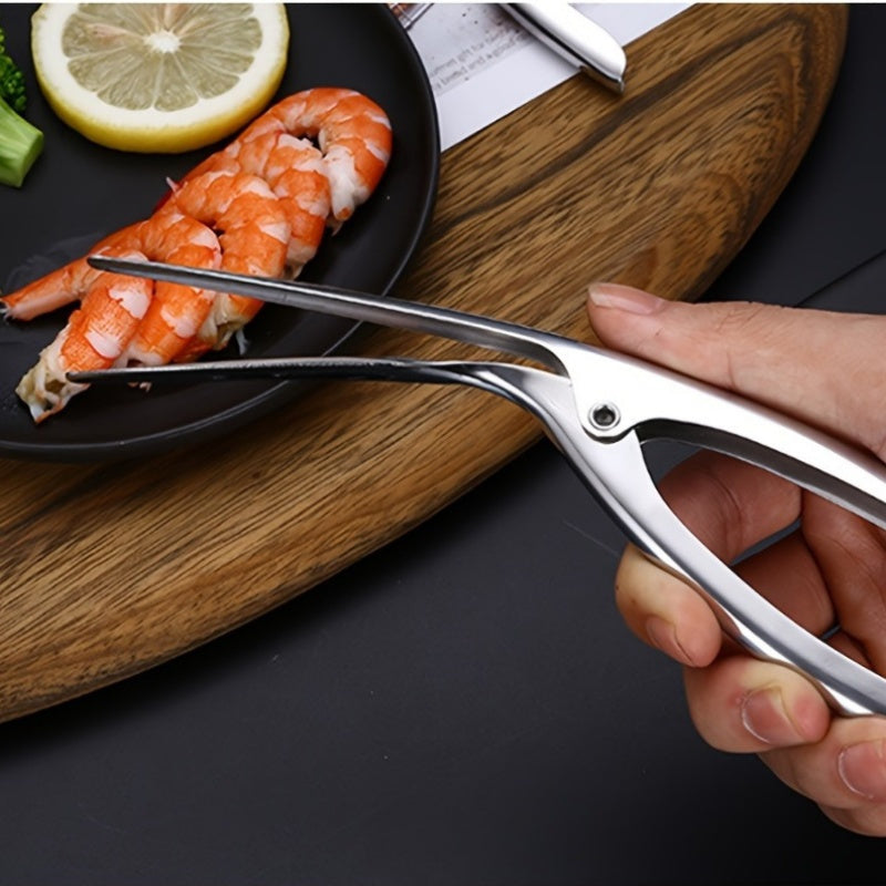 Effortlessly remove shrimp shells with this stainless steel deveiner peeler featuring a comfort grip handle. This kitchen utensil is designed for easy shrimp preparation and is made with food contact safe material.