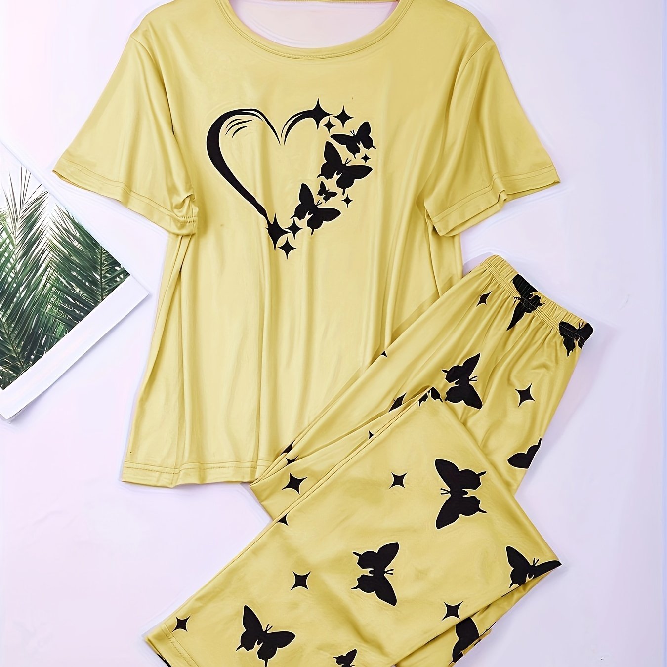 Heart and butterfly print pajama set for women, including a short sleeve top and loose long pants for lounging and sleeping.