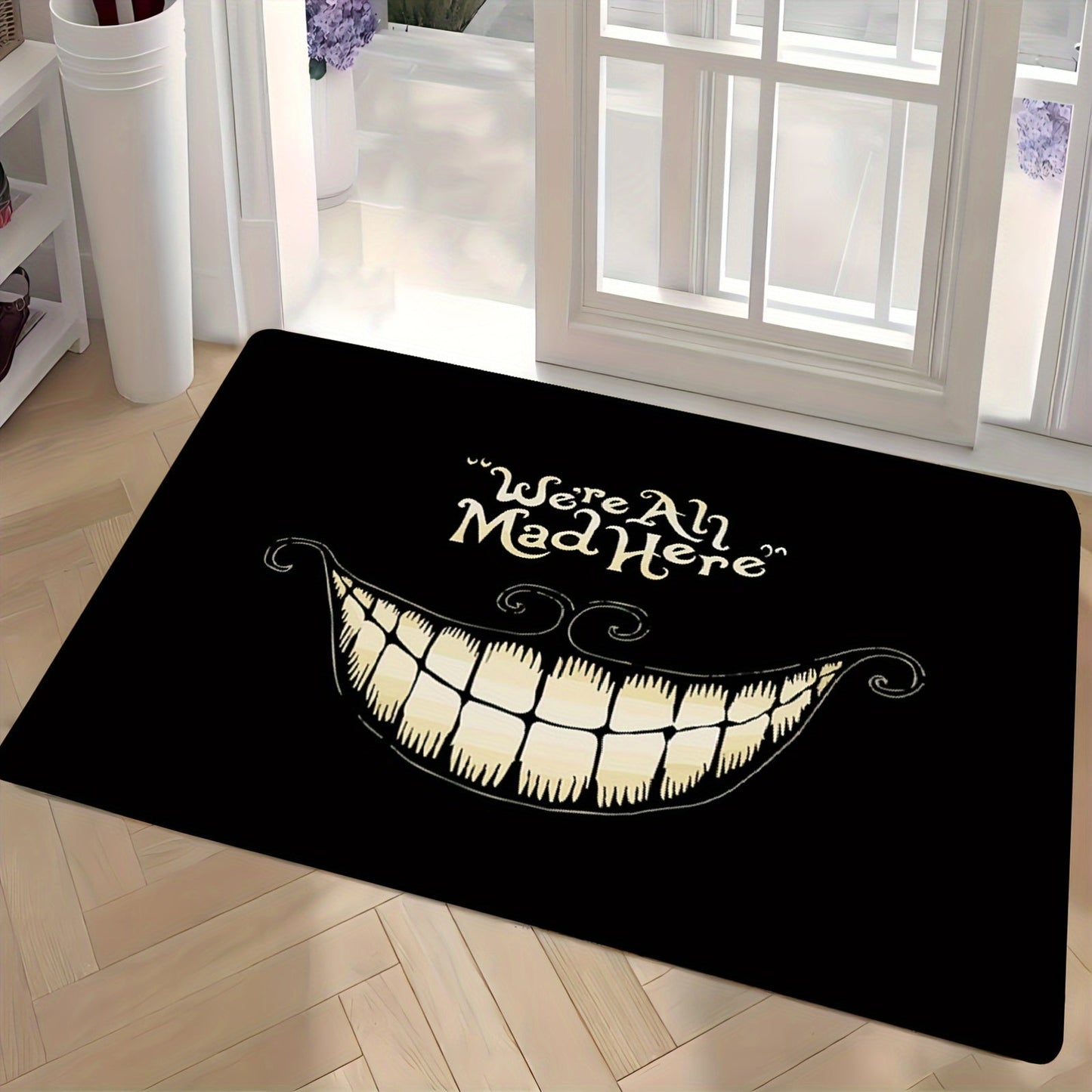 Welcome to Cheshire Smile Doormat - A soft and absorbent entrance mat made from polyester fleece, featuring a charming tooth and letter print design. This 1cm thick mat is anti-slip and perfect for your living room, bedroom, front door, or hallway. Add a