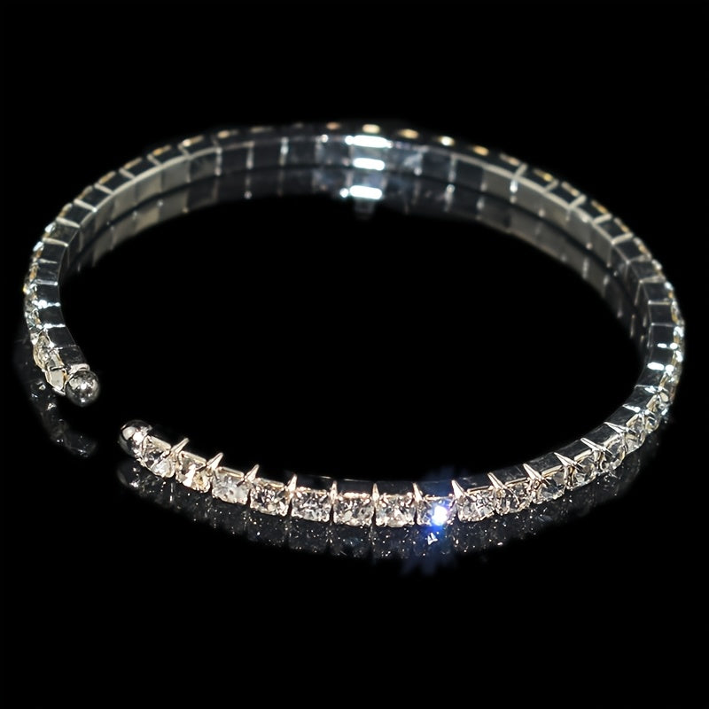 Elegant silvery-plated bracelet with cubic zirconia in classic single row design for weddings and everyday glam.