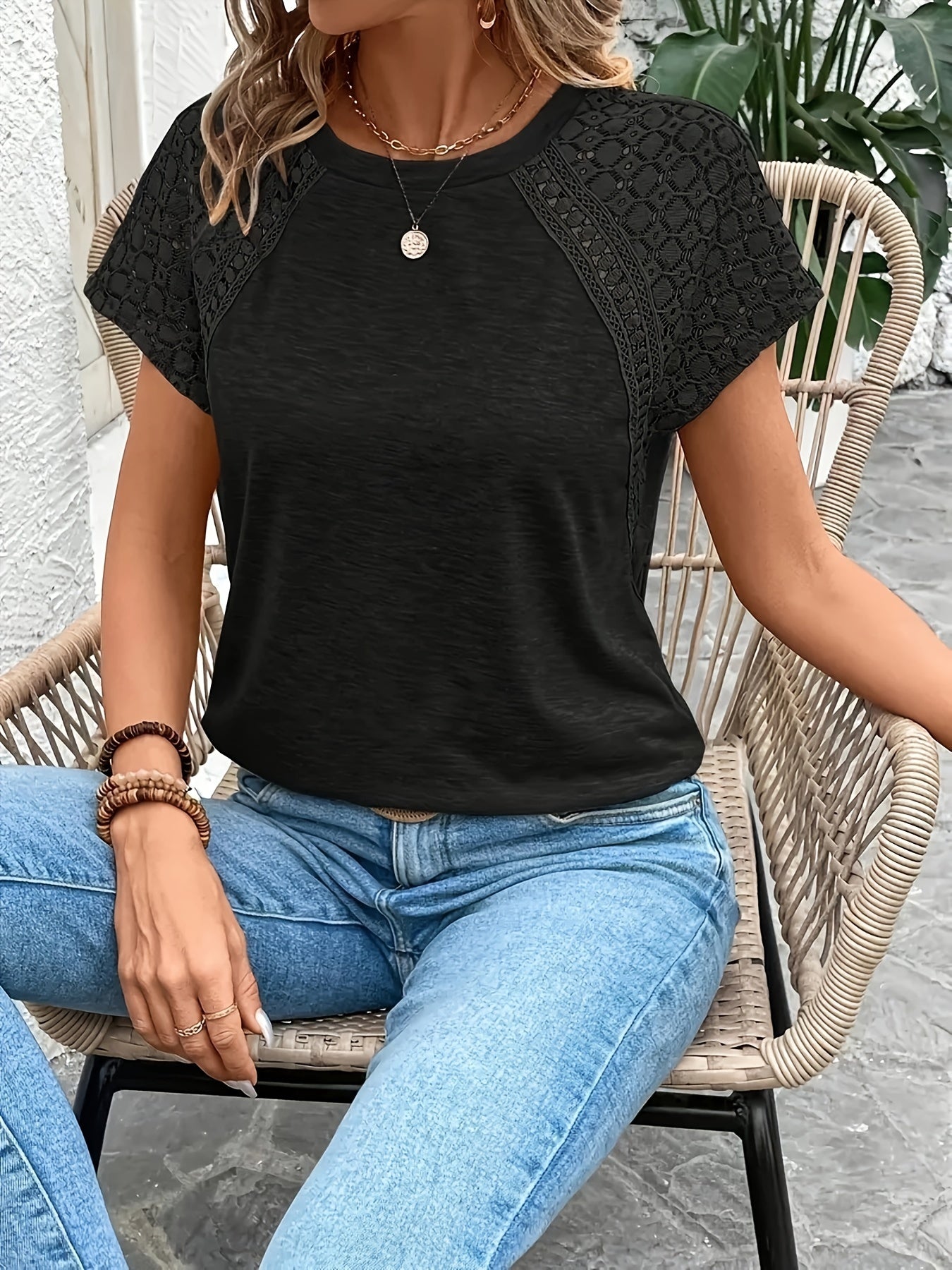 Elegant black short sleeve T-shirt for women with lace detail. Made of polyester with medium stretch. Suitable for spring, summer, and fall fashion. Features crew neck and knit fabric.