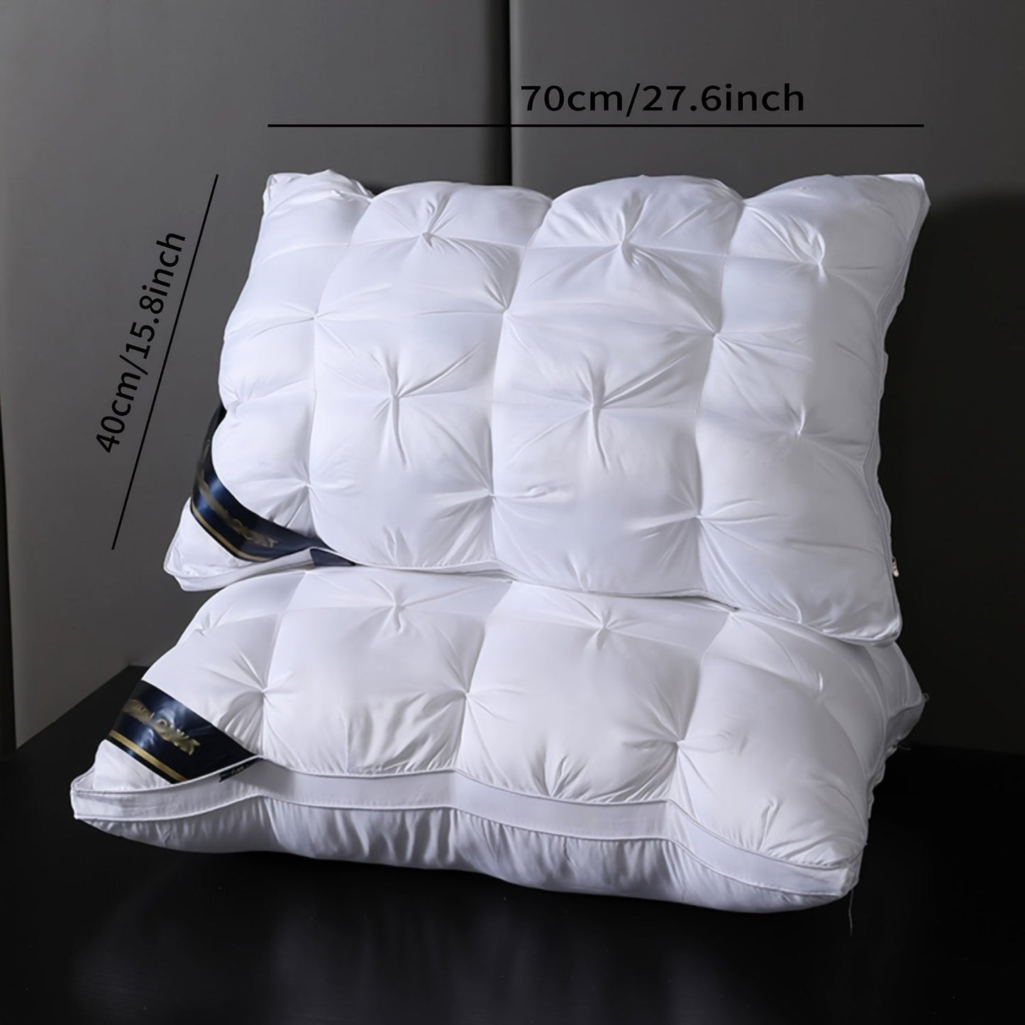 Two high-quality microfiber pillows for luxurious hotels, designed with a compressible flower-crafted neck support and a soft polyester cover. These pillows are dry clean only, made with woven fabric and weigh 95 grams each. They offer a moderate