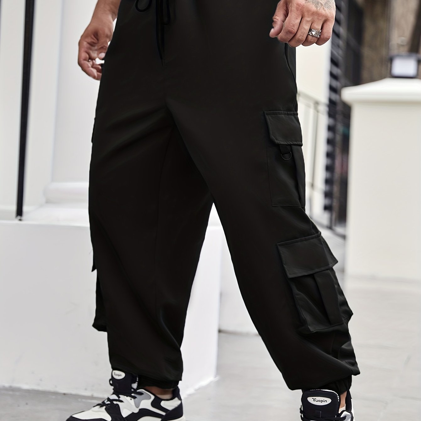 Men's plus size cargo pants with pockets for spring and fall fashion.