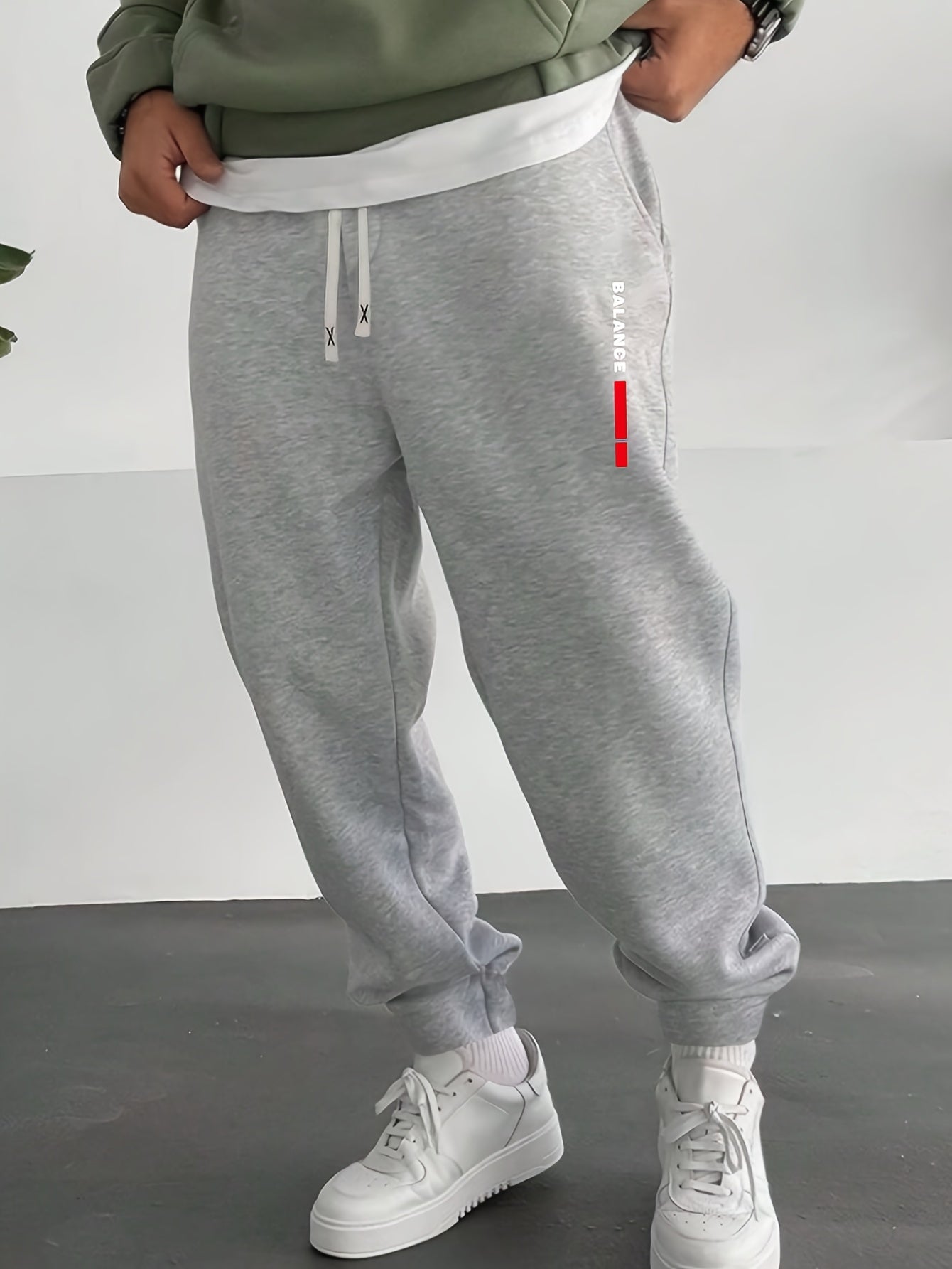 Casual men's sweatpants with letter print, made of polyester knit fabric with stretch. Regular fit with drawstring waist, comfortable for fall/winter.