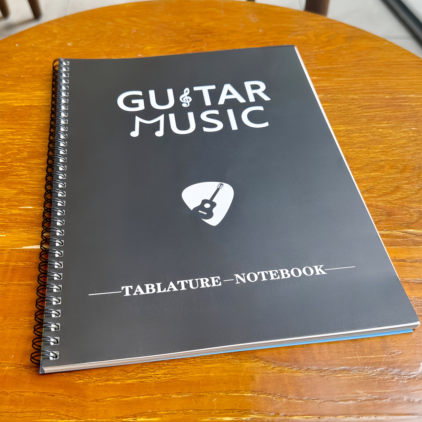 50-sheet guitar music creation and practice staff notebook with blank chord diagrams and 56 commonly used guitar chord diagrams on inside cover.