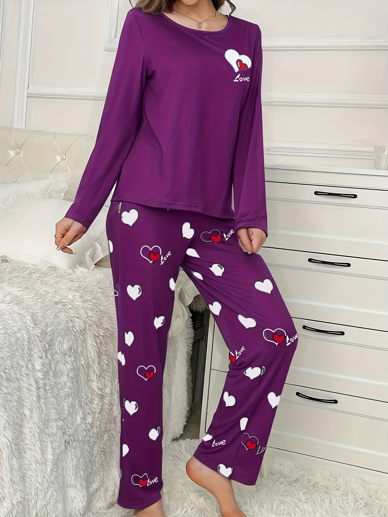 Women's heart print 2-piece pajama set includes long sleeve crew neck top and elastic waist pants in cozy polyester blend for fall/winter.