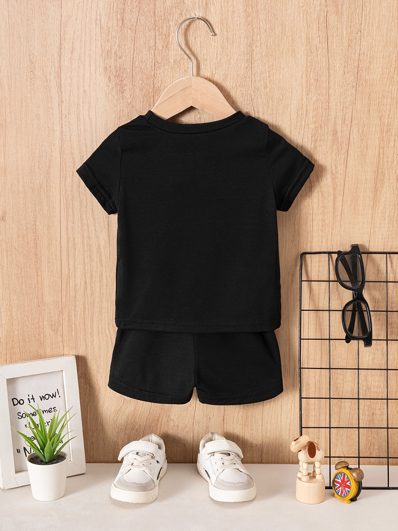 Two baby boy casual "slogan" t-shirt and shorts set made of polyester knit fabric, featuring a cute regular fit. The set includes a short sleeve crew neck tee with solid color shorts