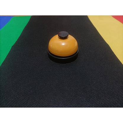 Colorful metal hand-press training bell for dogs & cats with red, yellow, & green bells on black background. Durable & easy-to-use pet trainer.