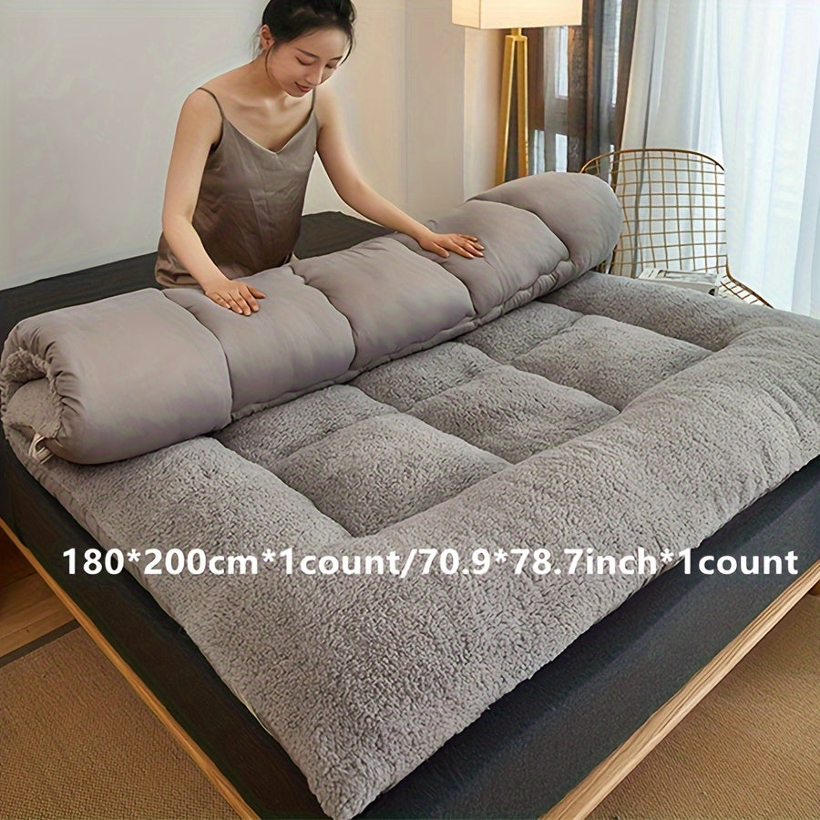 Soft, reversible gray mattress protector with corner straps for easy storage and transport. Ideal for cozy bedrooms.