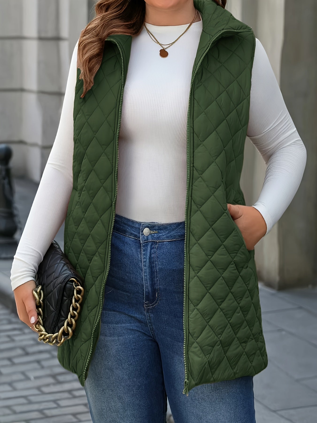 Chic plus-size quilted vest with stand collar and mid-length zip-up closure for winter wear.