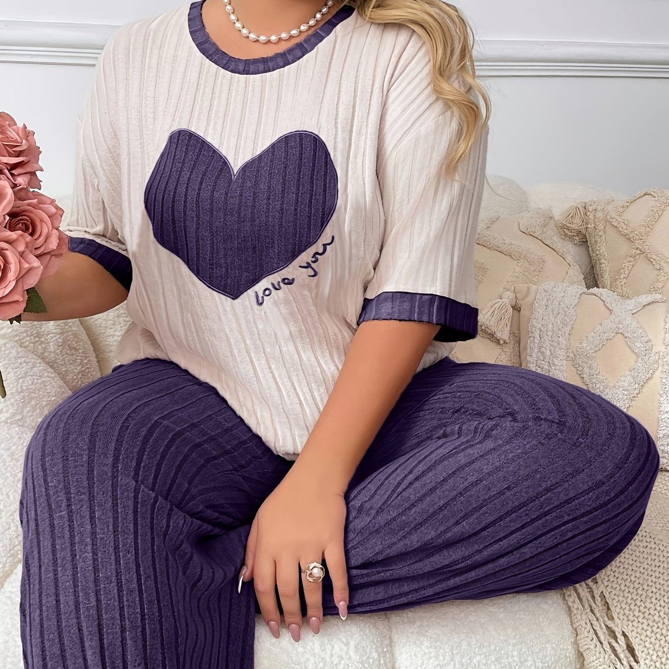 Cozy heart embroidered pajama set in plus size, includes short sleeve top and long pants made of soft polyester. Machine washable.