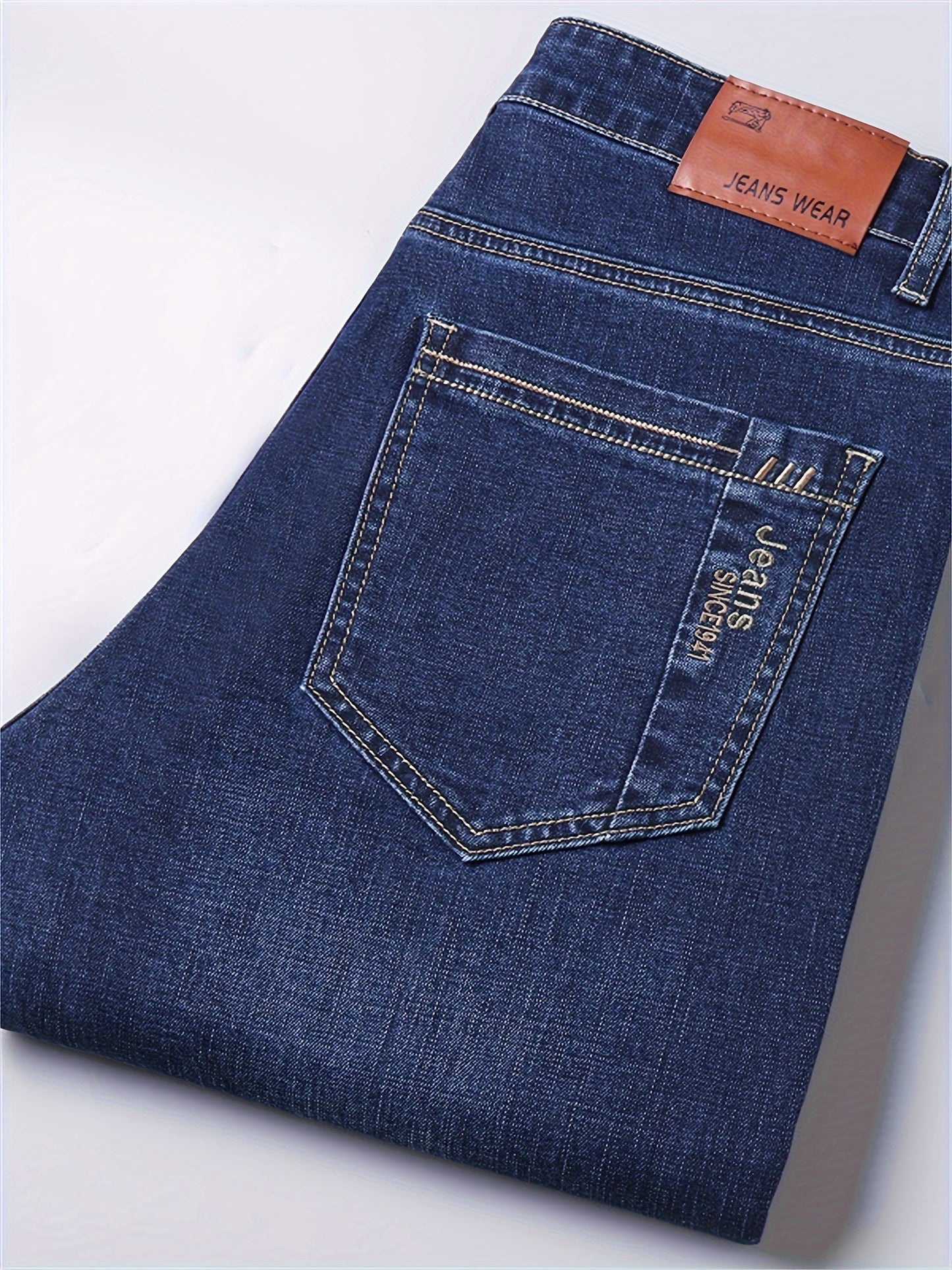 Men's casual cotton blend jeans with pockets, ideal for outdoor activities.