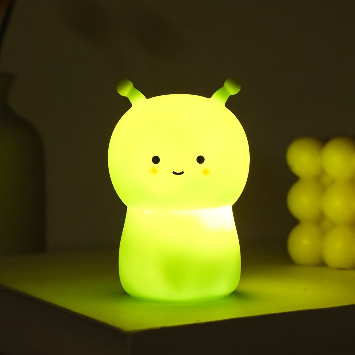 Kid-friendly LED nightlight featuring cartoon dinosaur and bug design in pink and green colors.