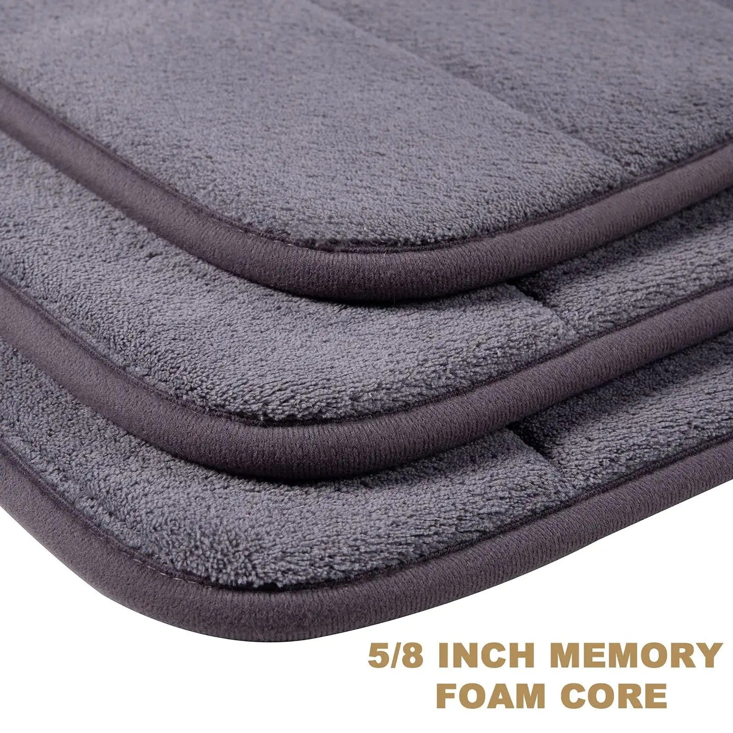 Soft polyester blend bath mat in plush dark gray stripes, featuring a non-slip PVC backing for added safety. Easily machine washable for convenience, this rectangular mat is perfect for adding comfort to your bathroom décor.