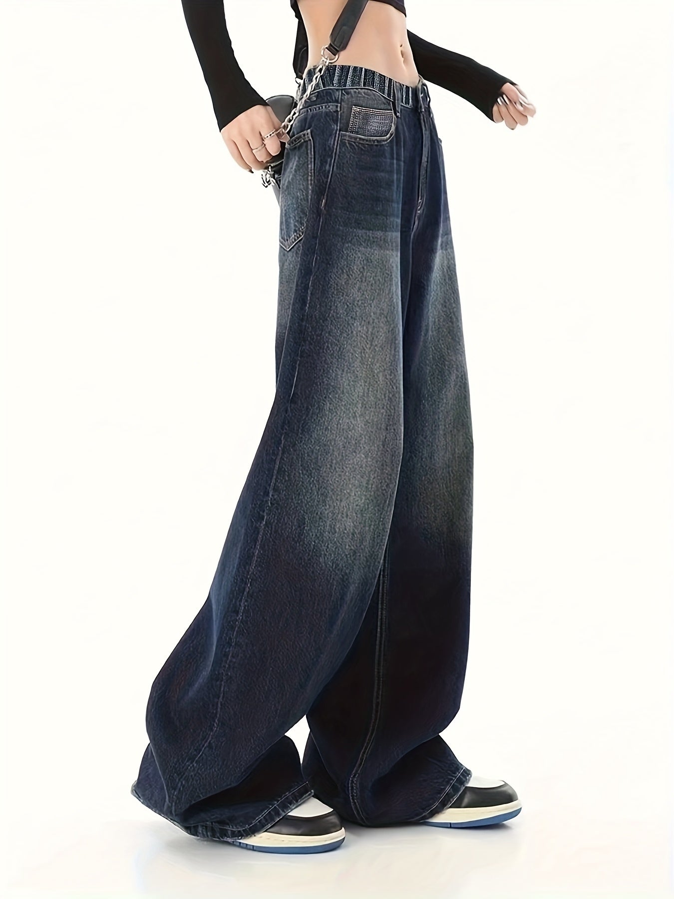 Youth wide-leg denim jeans with side pockets, elastic waist, and solid color. Non-stretch fabric suitable for all seasons.