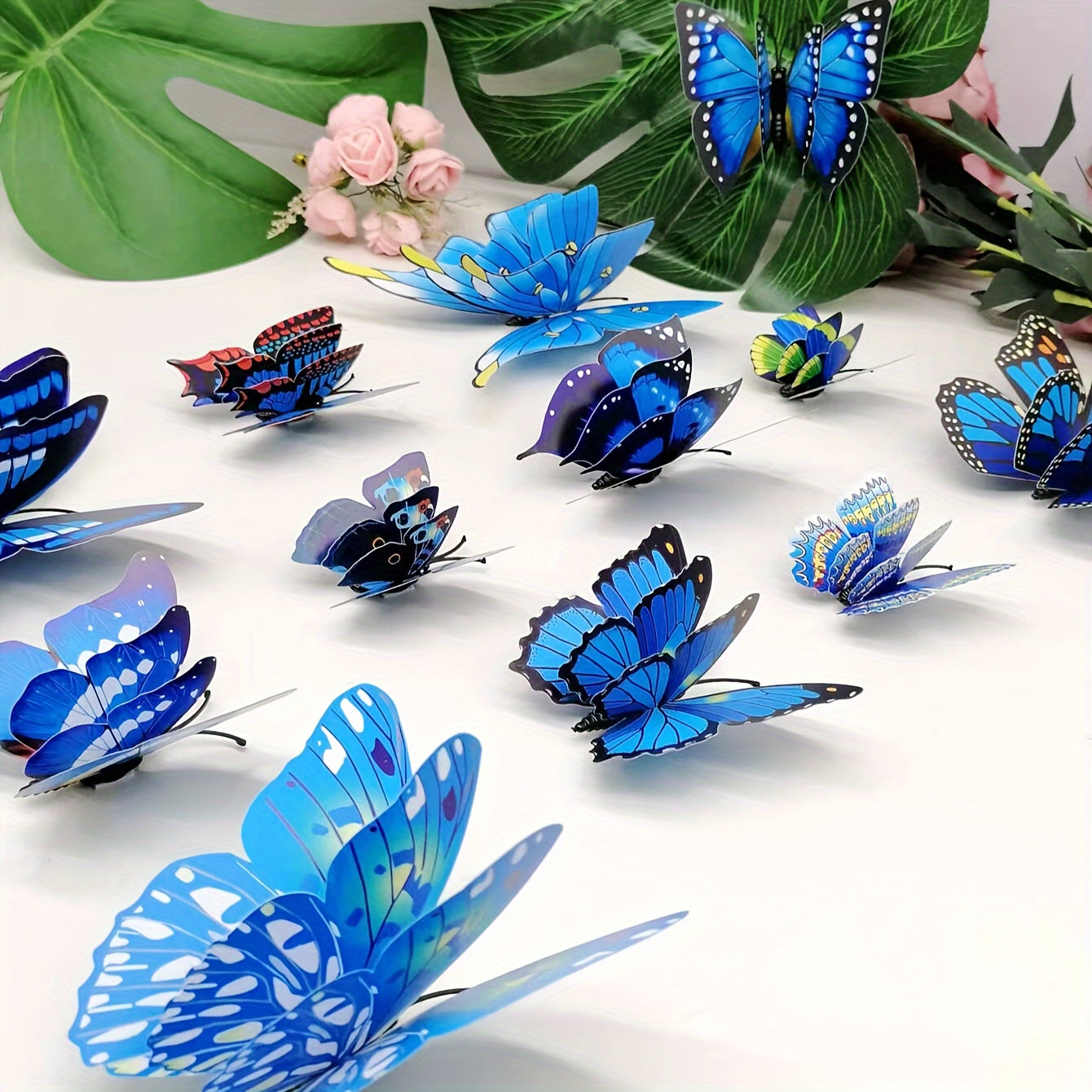 12pcs of vibrant 3D butterfly wall decals in blue shades, double-layer design, removable and self-adhesive stickers for home decor, parties, and weddings. Made of paper, these butterfly decorations are perfect for adding a touch of nature to your living