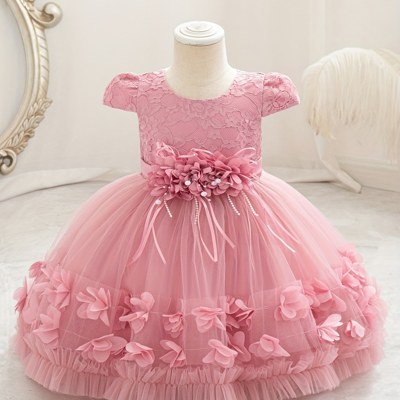 Baby's floral tulle princess dress with lace sleeves for formal occasions.