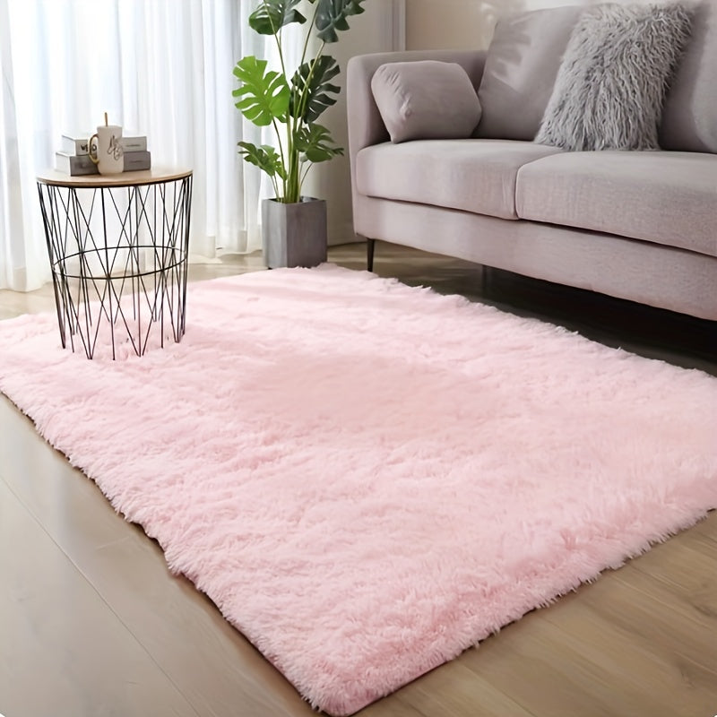 This solid pink polyester area rug is both fluffy and durable, making it perfect for any room in your home or office. The non-slip backing ensures safety, while the stain-resistant material is easy to clean with dry cleaning. This machine-made