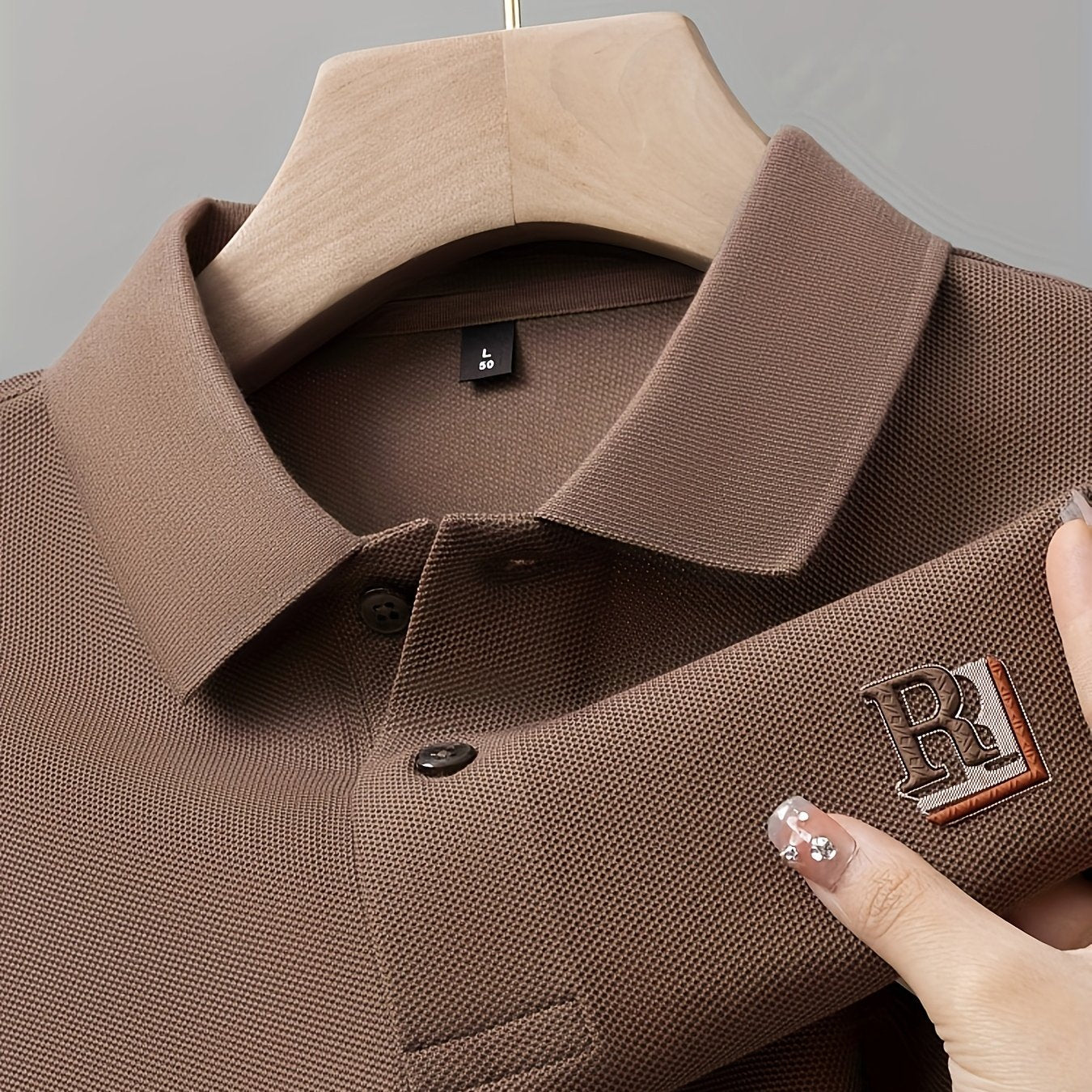 Men's casual long sleeve polo shirt with embossed letter detail, made of 100% polyester knit fabric. Features medium stretch, regular fit, lapel collar, half placket, 3D printed alphabet