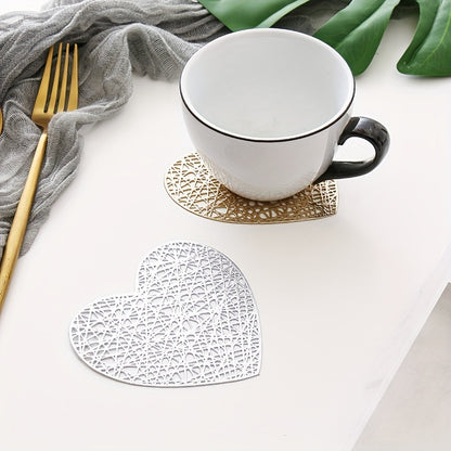 Set of 4 heart-shaped placemats and coasters made of PVC with heat insulation and non-slip features, ideal for household decoration and meal protection on dining tables.