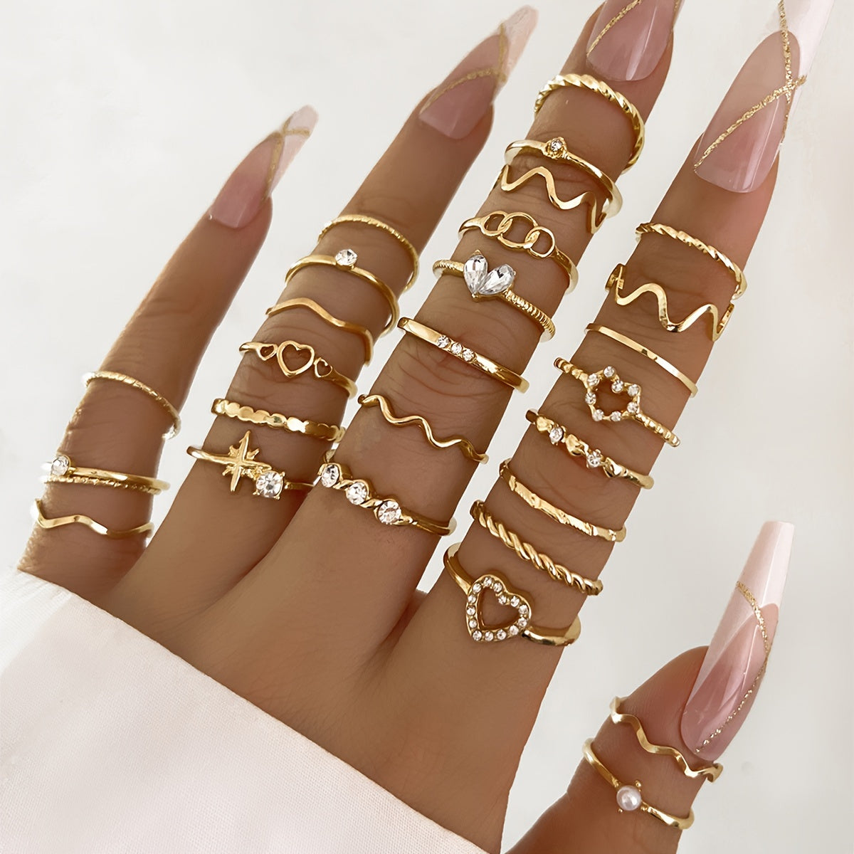 A 28-piece set of stylish alloy iron stacking rings with heart, geometric, and wavy designs for versatile wear.