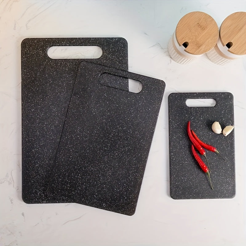 Set of three cutting boards with a marble pattern made of food-safe polystyrene. Suitable for chopping fruits and vegetables, these boards are durable, easy to clean, and feature a stylish black and white marble design.