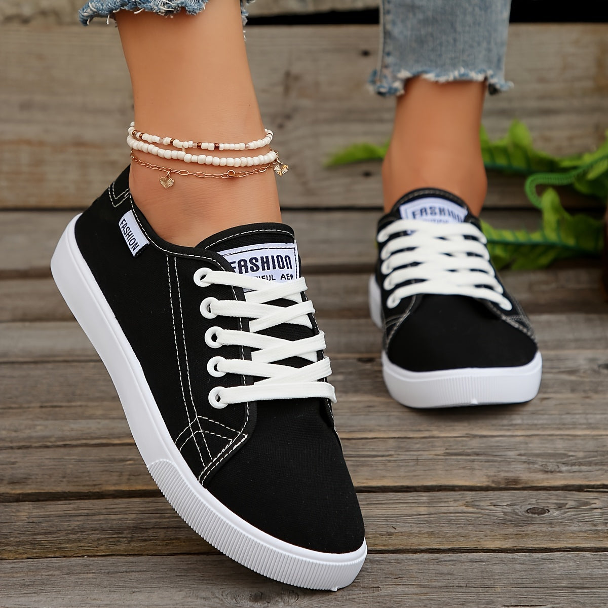 Black & white lace-up sneakers for women with round toe, low-top design, and comfortable EVA sole.