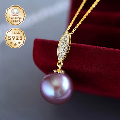 This stunning pendant necklace features a 13-14mm round natural freshwater pearl in an elegant shade of purple. The gemstone may have minor imperfections, adding to its unique beauty. The pendant is crafted from S925 silver and comes with a gift box