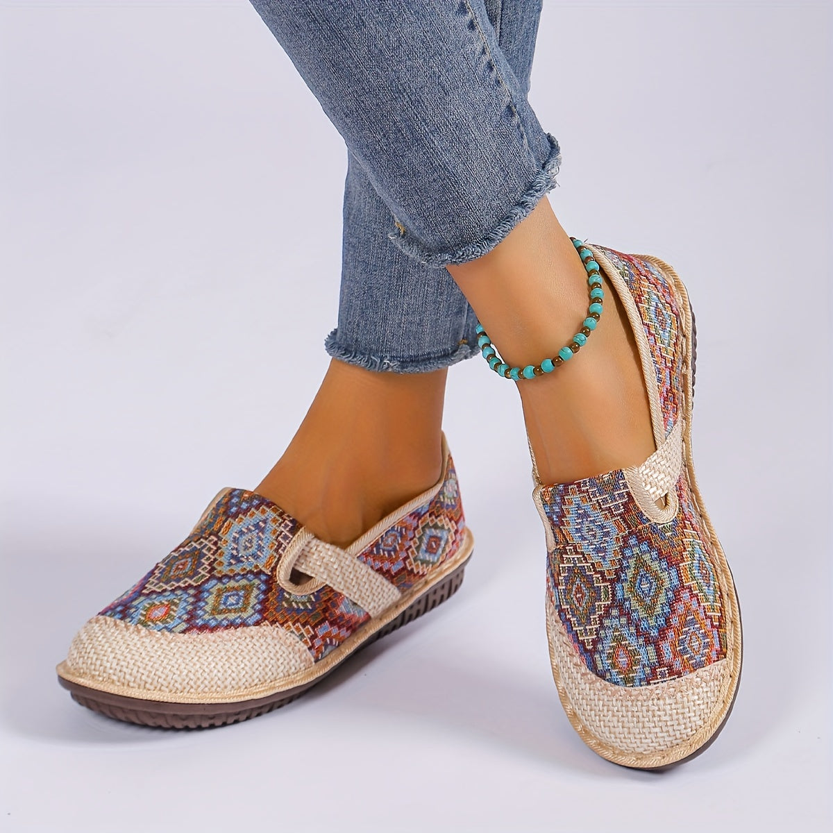 Women's printed slip-on mules with soft, lightweight soles.