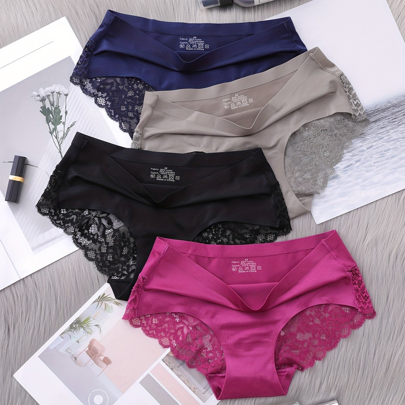 Set of 4 nylon knit fabric mid rise panties for women with solid color and lace details.