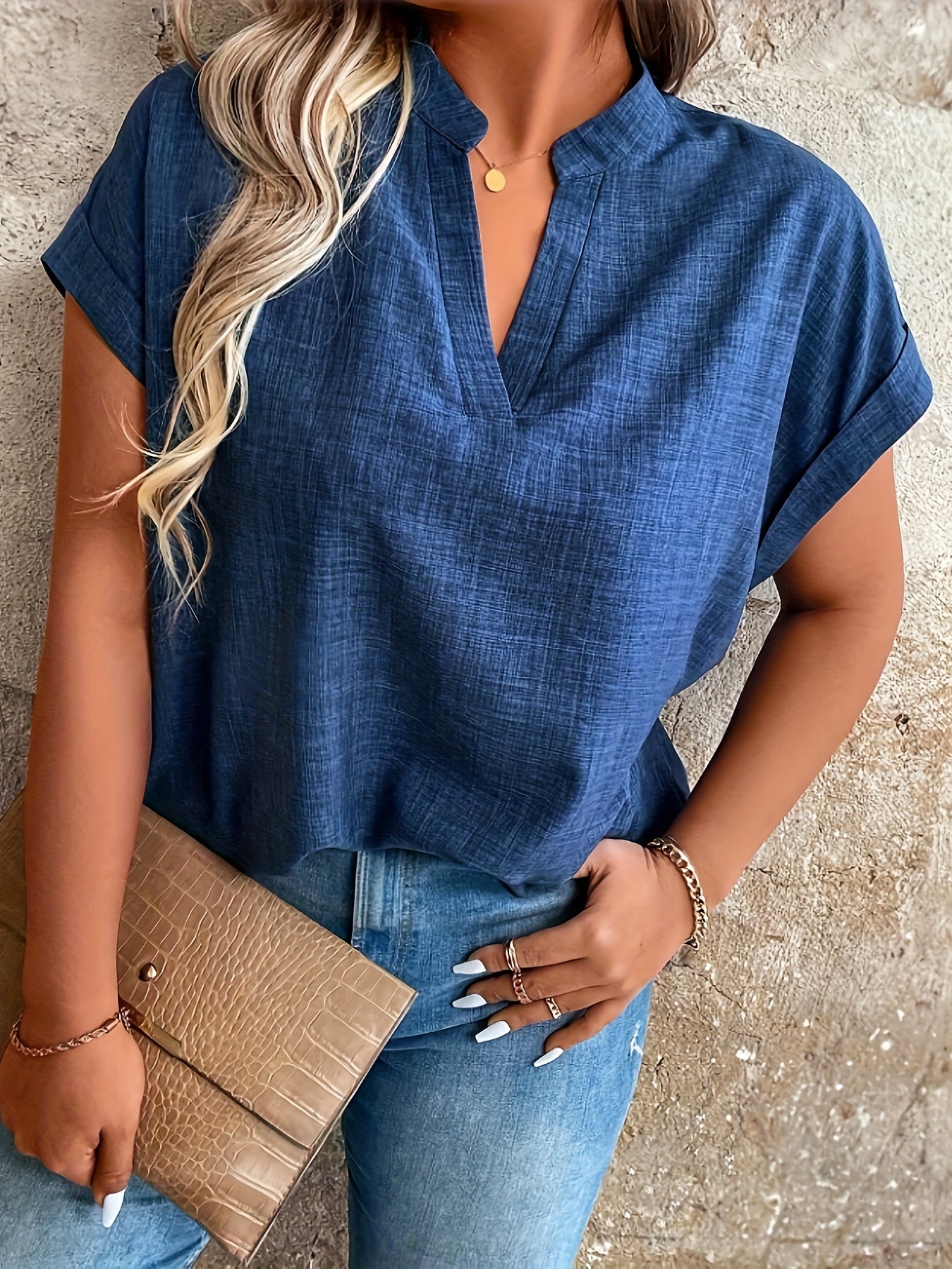 Elegant blue V-neck blouse with batwing sleeves, perfect for spring/summer. Made of machine washable polyester fabric, ideal for casual summer wear.