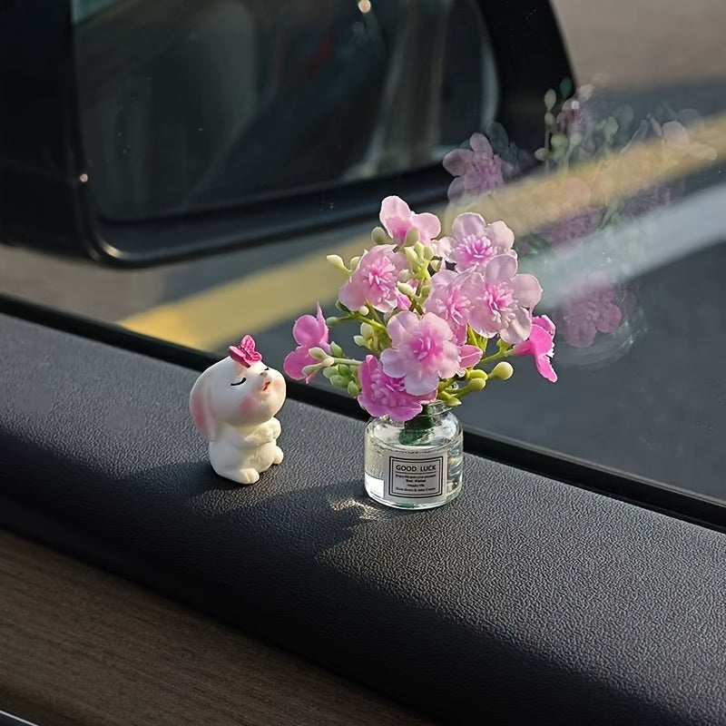 Miniature resin vase for car dashboard décor with healing figurine.