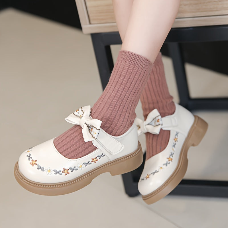 Girls' Mary Jane shoes for Fall 2024, featuring an elegant princess style with floral embroidery and bow detail. Non-slip rubber sole, hook-and-loop strap closure for school, parties, or