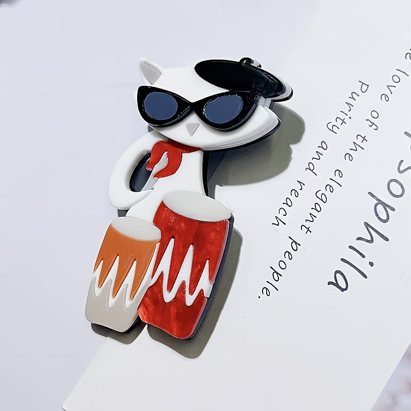 Elegant Cartoon Cat Drummer Brooch Pin, featuring an Acrylic Irregular Shape. This trendy Animal Musician Badge is the perfect Clothing Accessory, suitable for both Men and Women. Elevate your style with this Unisex Fashion Lapel Pin.