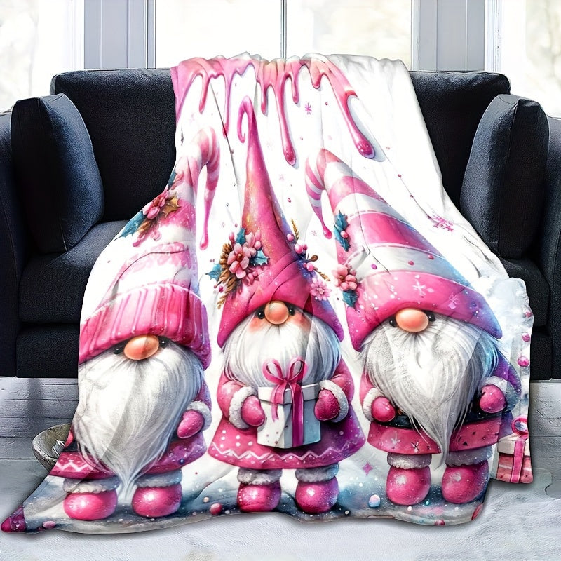 Soft, warm, and versatile flannel throw blanket featuring a cozy Christmas gnome and bell print. Perfect for snuggling on the couch, adding warmth to your office chair, staying cozy in bed, camping under the stars, or traveling in style. This all-season