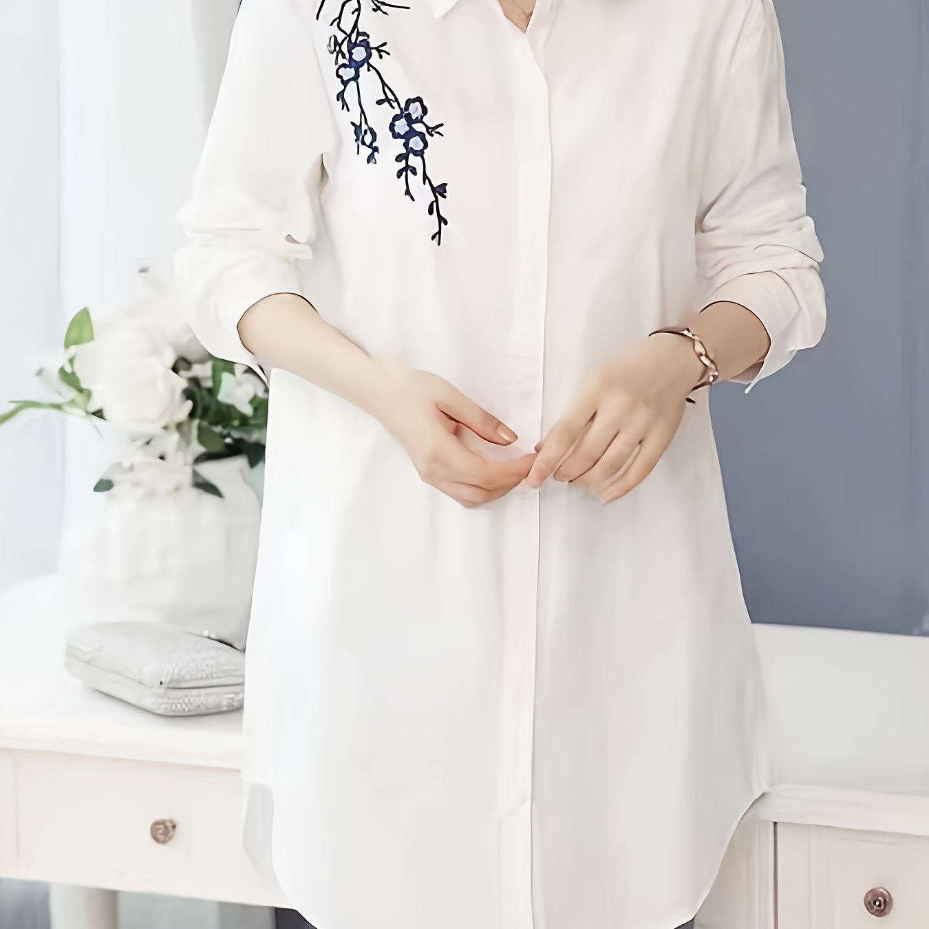 Stylish white polyester blouse with floral design, collared and machine washable for women; perfect for spring, summer, and fall.