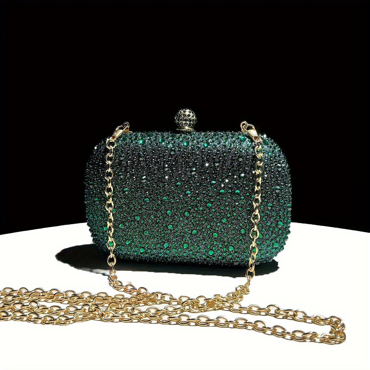 Stylish emerald green handbag with golden chain, suitable for formal events and as a gift for women.