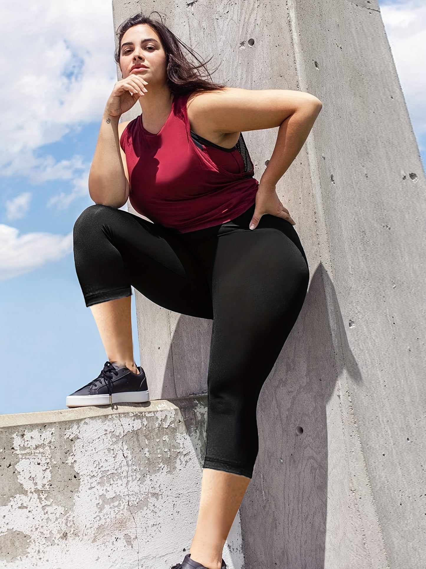 Plus size capri leggings for women, with high waist and tummy control. Features 4X stretch, pocket detail, and solid black color. Made from knit fabric, 92% polyester and 8% spandex