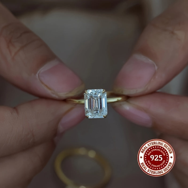 This stunning 925 Sterling Silver ring features a rectangular Cubic Zirconia stone, exuding elegance and luxury. It is perfect for both casual wear and gifting, with its simple yet sophisticated golden design. The simulated diamond comes in sizes of 1CT