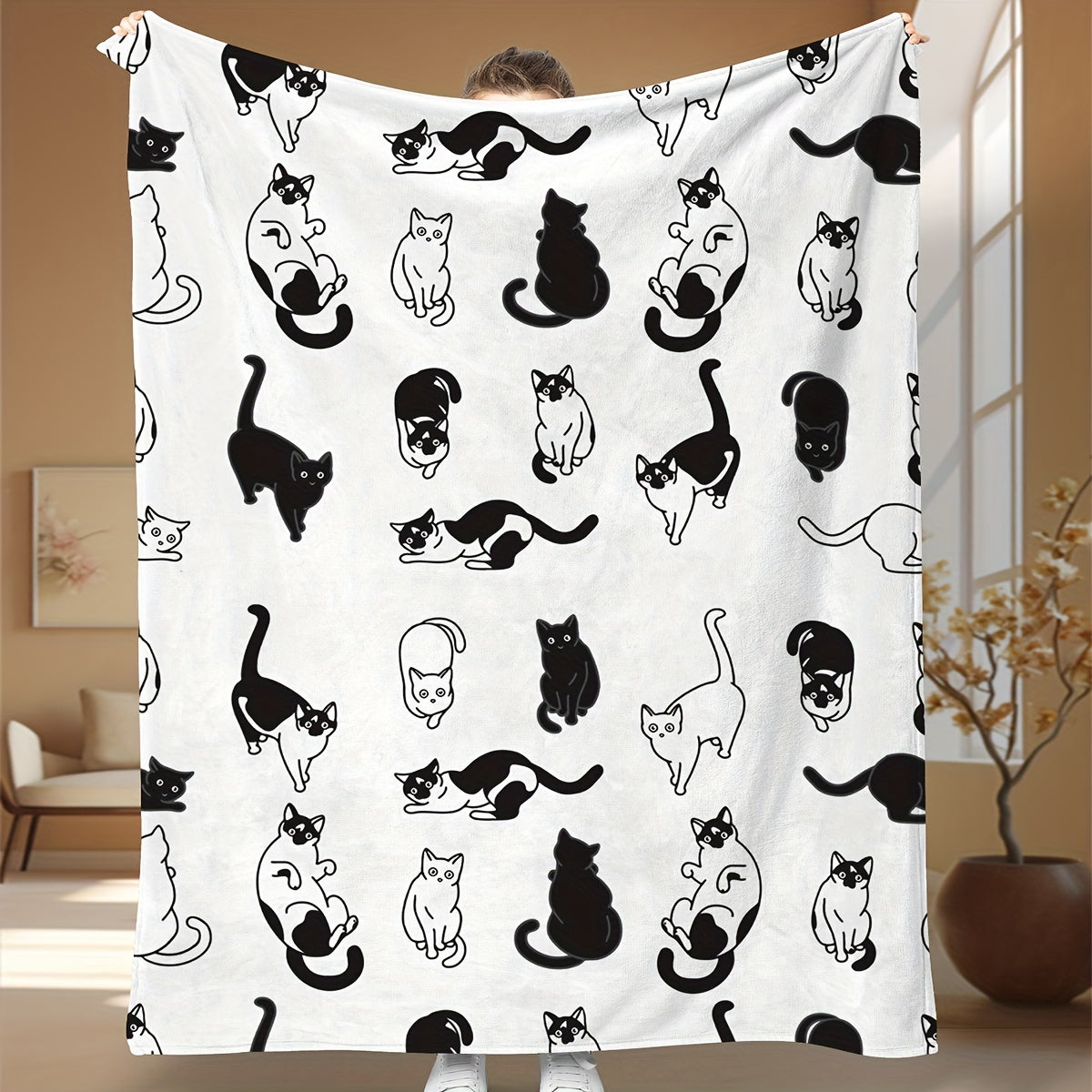 Soft and cozy fleece throw blanket featuring an adorable cartoon kitty print. Perfect for all seasons, this blanket is suitable for home, office, camping, and travel. Made from durable polyester fabric, it is machine washable for easy care. With a