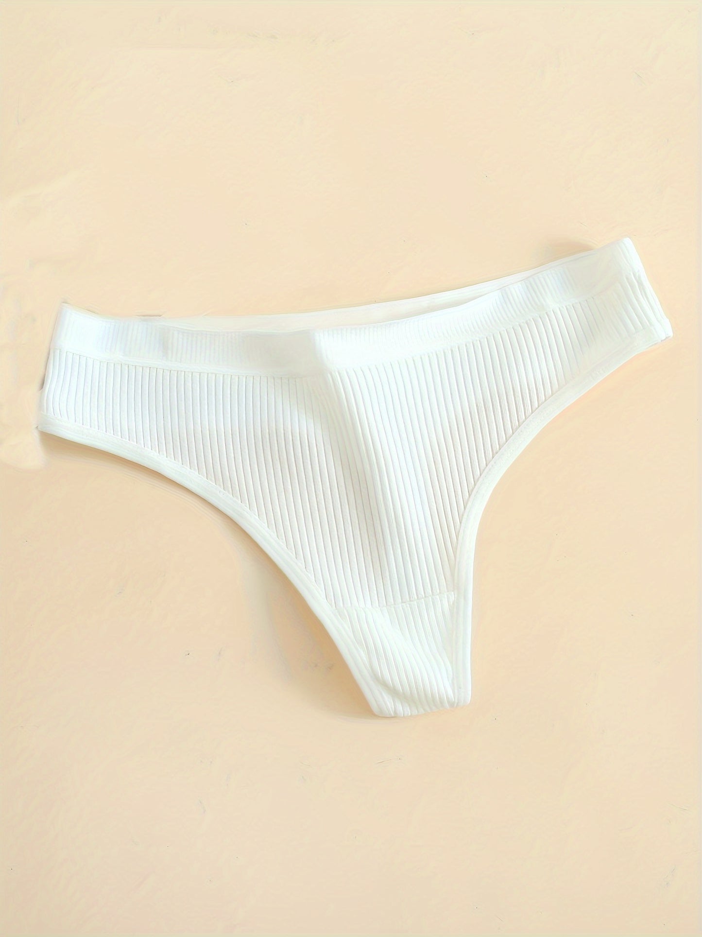 6-Pack of comfortable seamless cotton thongs for women, v-string style with low waist, solid color, simple design, and non-see-through fabric.