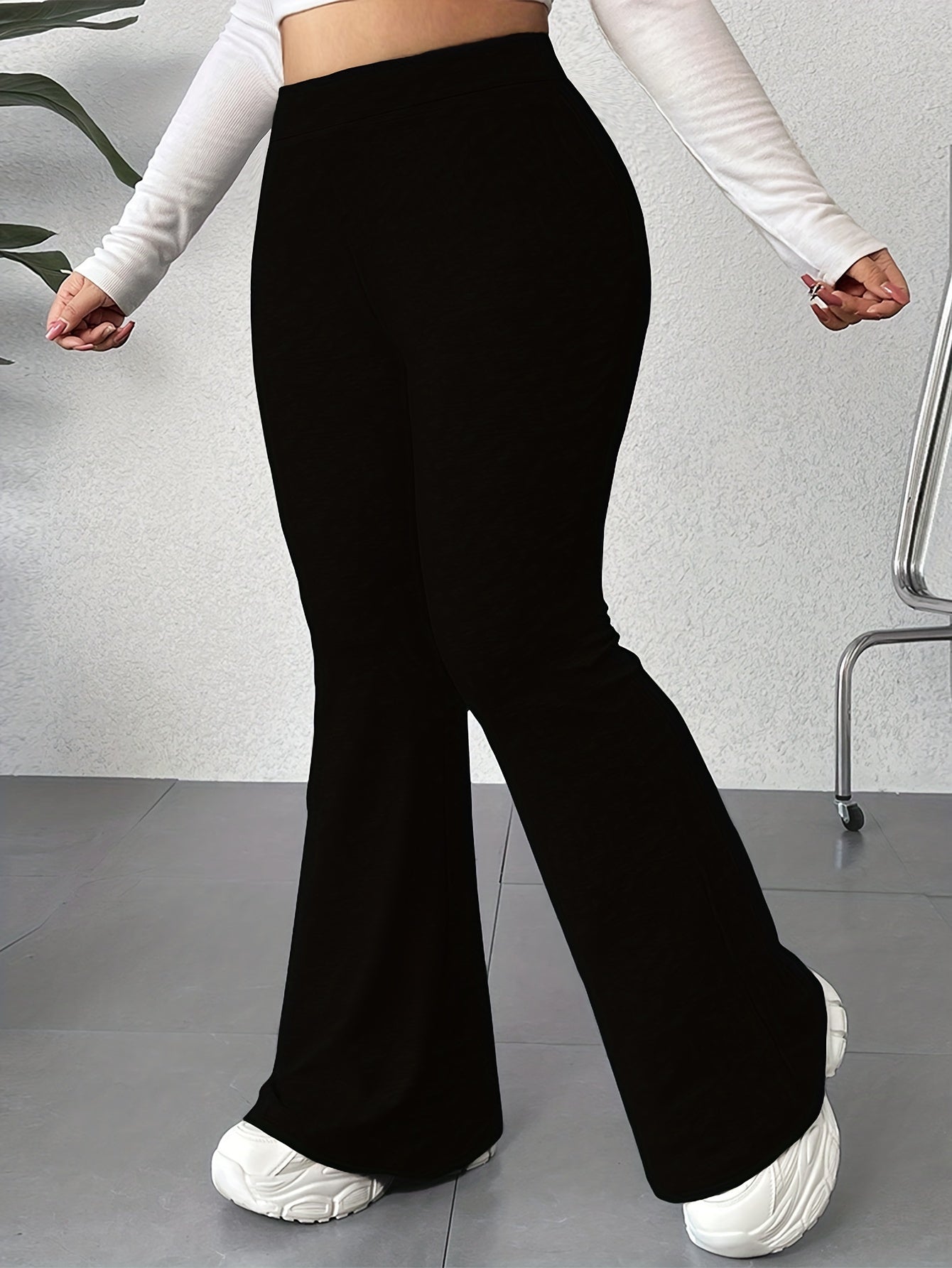 Solid color flared leg pants with a high waist, perfect for spring and summer in plus size women's clothing.